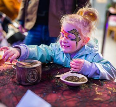 Girl making a potion at Eden Project